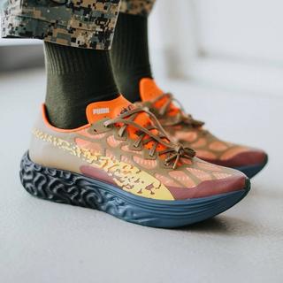 Salehe Bembury's PUMA Velum NITRO™ running shoe in an orange color scheme.