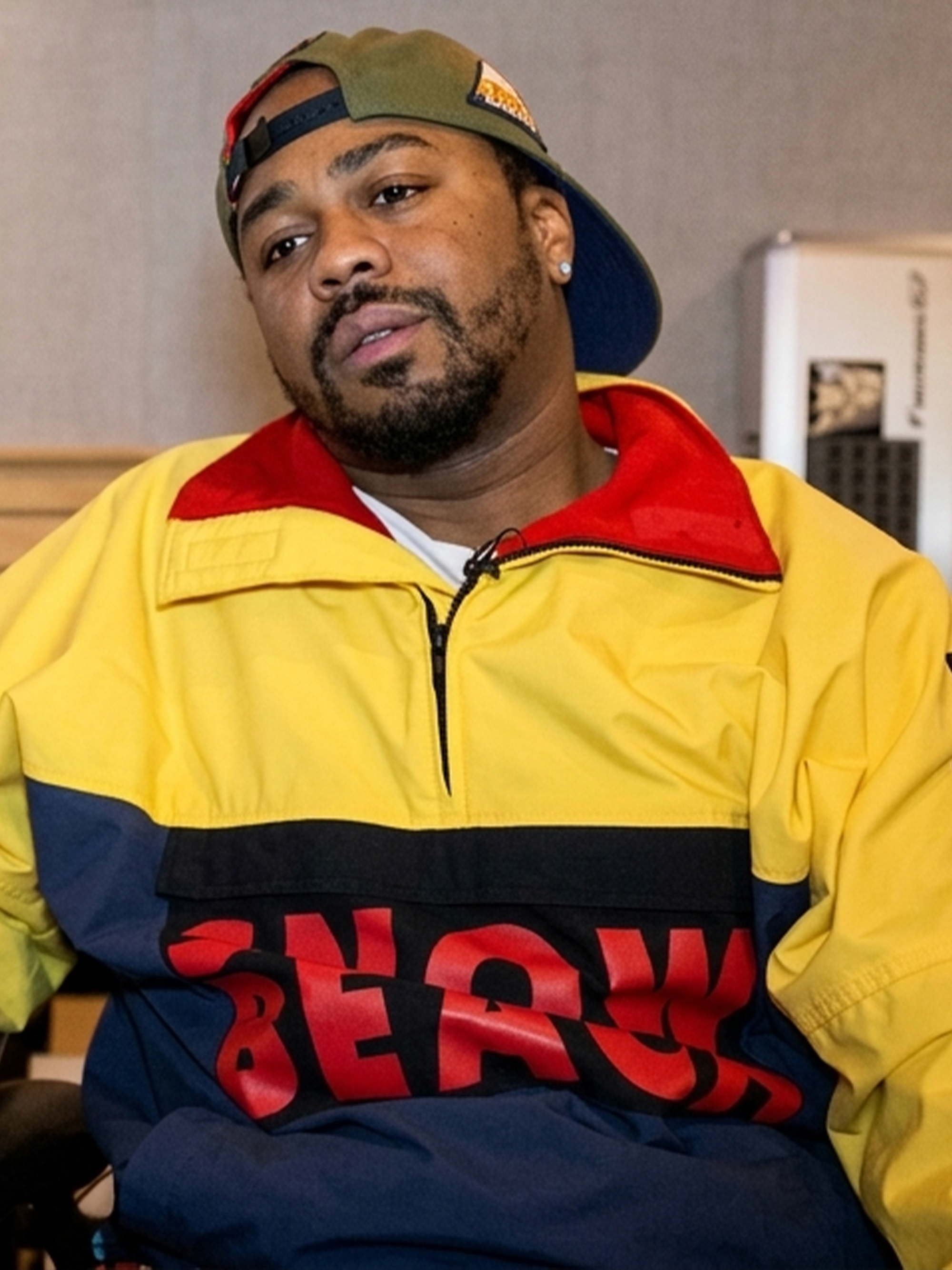 Just Blaze wearing Polo Ralph Lauren's "Snow Beach" Pullover Jacket in an interview about his and Packer Shoes' similar Saucony Grid 9000 collaboration from August 2014.