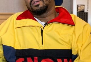 Just Blaze wearing Polo Ralph Lauren's "Snow Beach" Pullover Jacket in an interview about his and Packer Shoes' similar Saucony Grid 9000 collaboration from August 2014.
