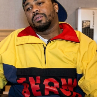 Just Blaze wearing Polo Ralph Lauren's "Snow Beach" Pullover Jacket in an interview about his and Packer Shoes' similar Saucony Grid 9000 collaboration from August 2014.