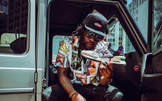 Wale holding a pair of the "No Days Off" New Balance 997S collaboration by Bodega, circa May 2019.