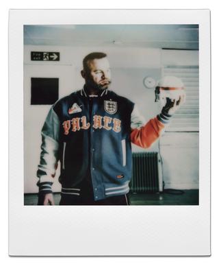 Wayne Rooney wearing the Palace x Nike Varsity Jacket for the English Football Association. Photo via Nike.