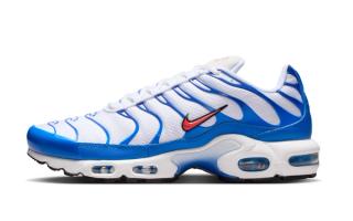 Nike Air Max Plus in a "White/Signal Blue/Old Royal/Team Orange" color scheme.