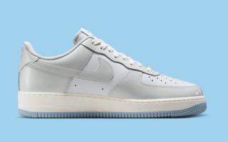 Medial angle of Nike's Air Force 1 Low in a "White/Light Armory Blue/Photon Dust" color scheme.