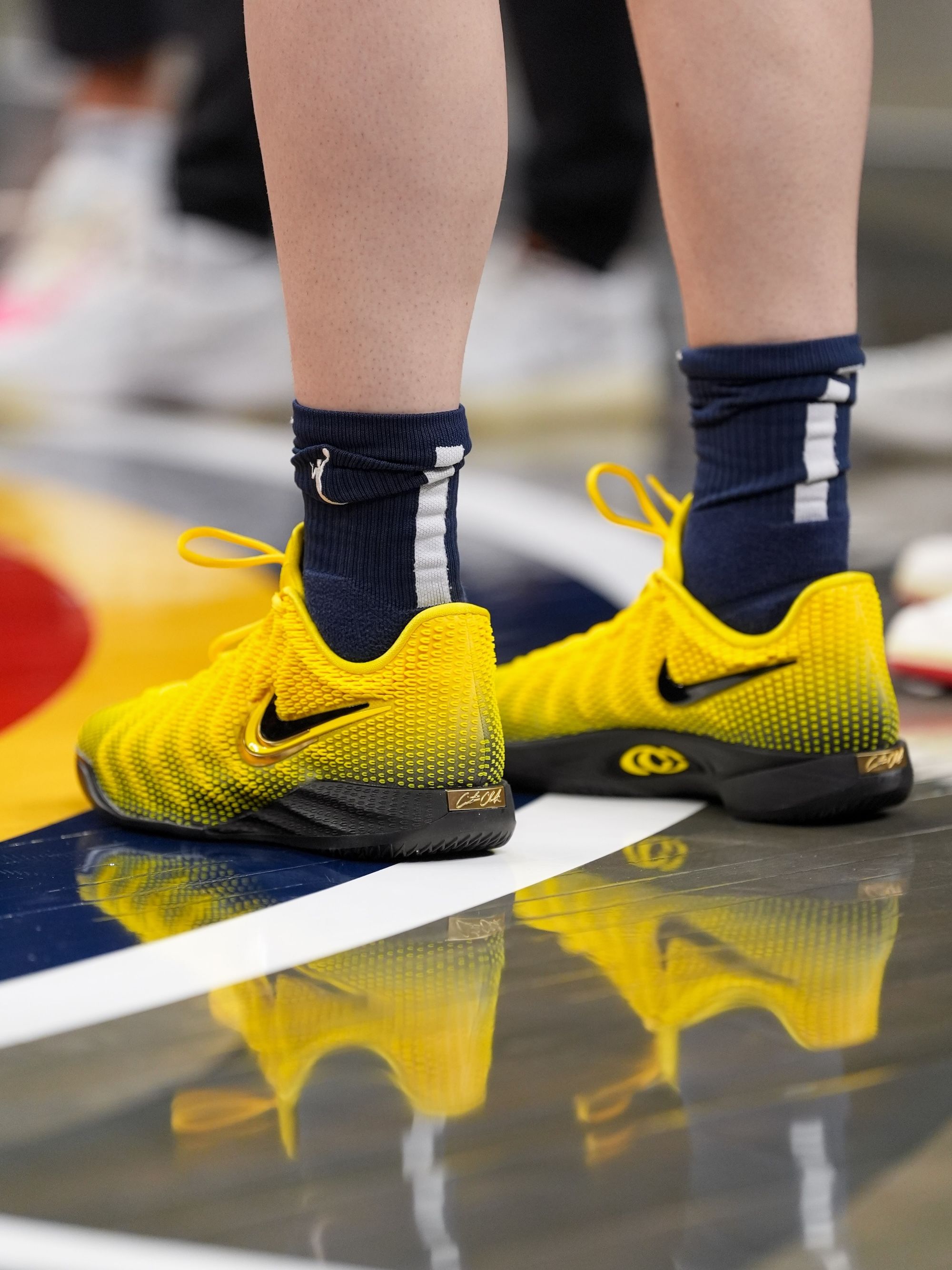 Caitlin Clark's Nike Caitlin 1 basketball shoe in a "Electric Green/Varsity Maize/Dusty Cactus/Chlorophyll/Racer Blue" color scheme. Photo via Caitlin Clark on Instagram Stories.