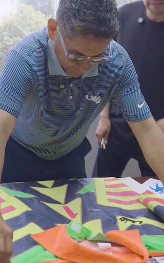 Jorge Campos inspecting Campos x Jorge retro Nike jersey. Screenshot via Jorge Campos.
