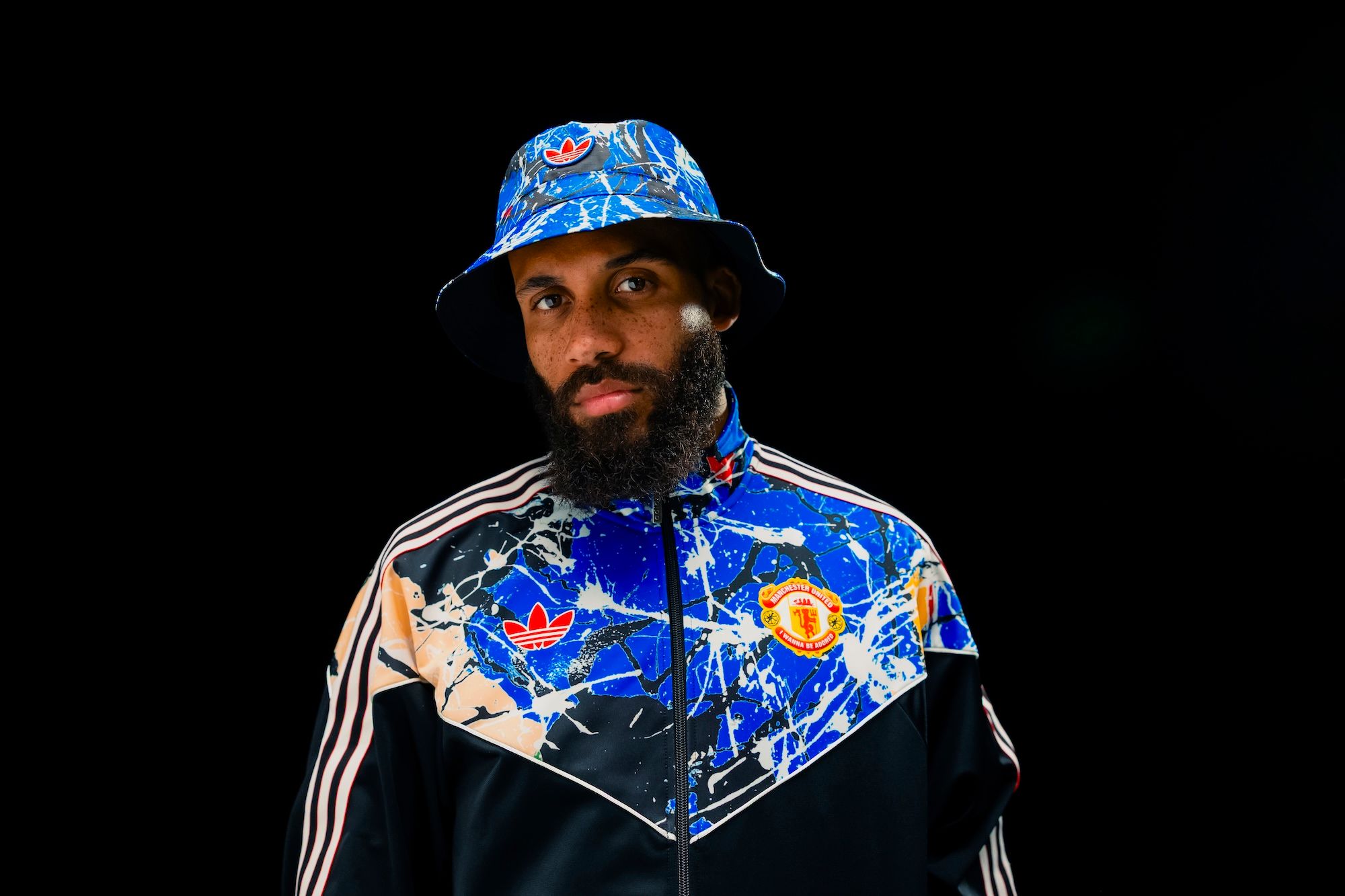 Bryan Mbeumo modeling the Manchester United x The Stone Roses Capsule by adidas.