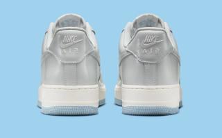 Heel angle of Nike's Air Force 1 Low in a "White/Light Armory Blue/Photon Dust" color scheme.