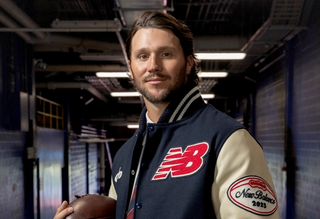 Buffalo Bills Quarterback Josh Allen in a New Balance letterman jacket.