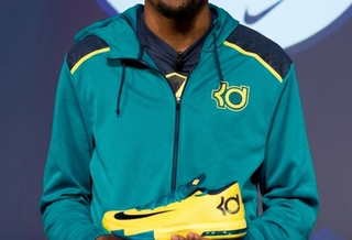 Kevin Durant holding the Nike KD 6 "Seat Pleasant" basketball shoe at a launch event in July 2013.