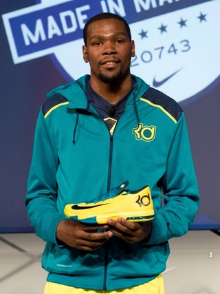 Kevin Durant holding the Nike KD 6 "Seat Pleasant" basketball shoe at a launch event in July 2013.