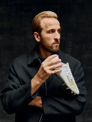 Harry Kane holding a special Skechers Ballon d'Or SKX_2 boots commemorating his 2026 win of the award. Photo via Skechers Football.