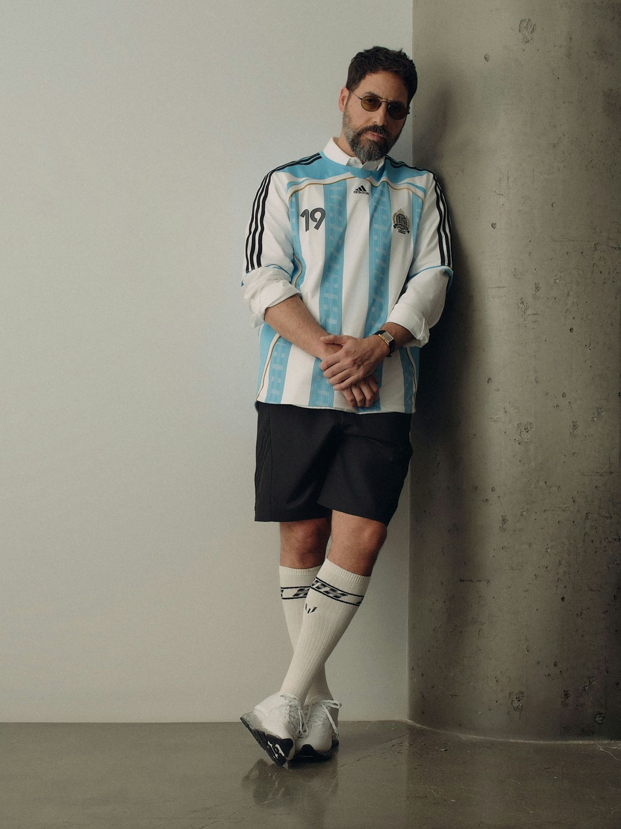 Ronnie Fieg wearing the Messi-inspired 2006 Argentina Home Jersey by Kith x adidas Football. Photo via Design District.