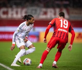 Michael Olise playing in a white pair of the Nike Hypervenom III football boots from 2018.