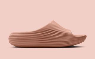Medial angle of the Women's Nike ReactX Rejuven8 Slide in a "Rose Gold" color scheme.