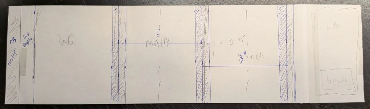 Hand-drawn label dieline on paper: info, main and French panels, hatched no-go zones at the tub's corners, a half-inch overlap and a barcode panel