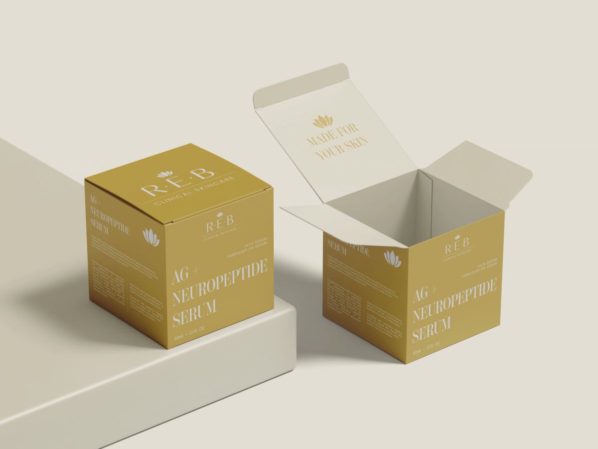 Two gold REB cartons for AG+ Neuropeptide Serum, one open to show a printed message inside the lid