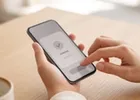 Close-up of hands making a bank transfer on a smartphone.