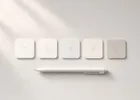 Overhead view of numbered paper tabs arranged in a row beside a pen.