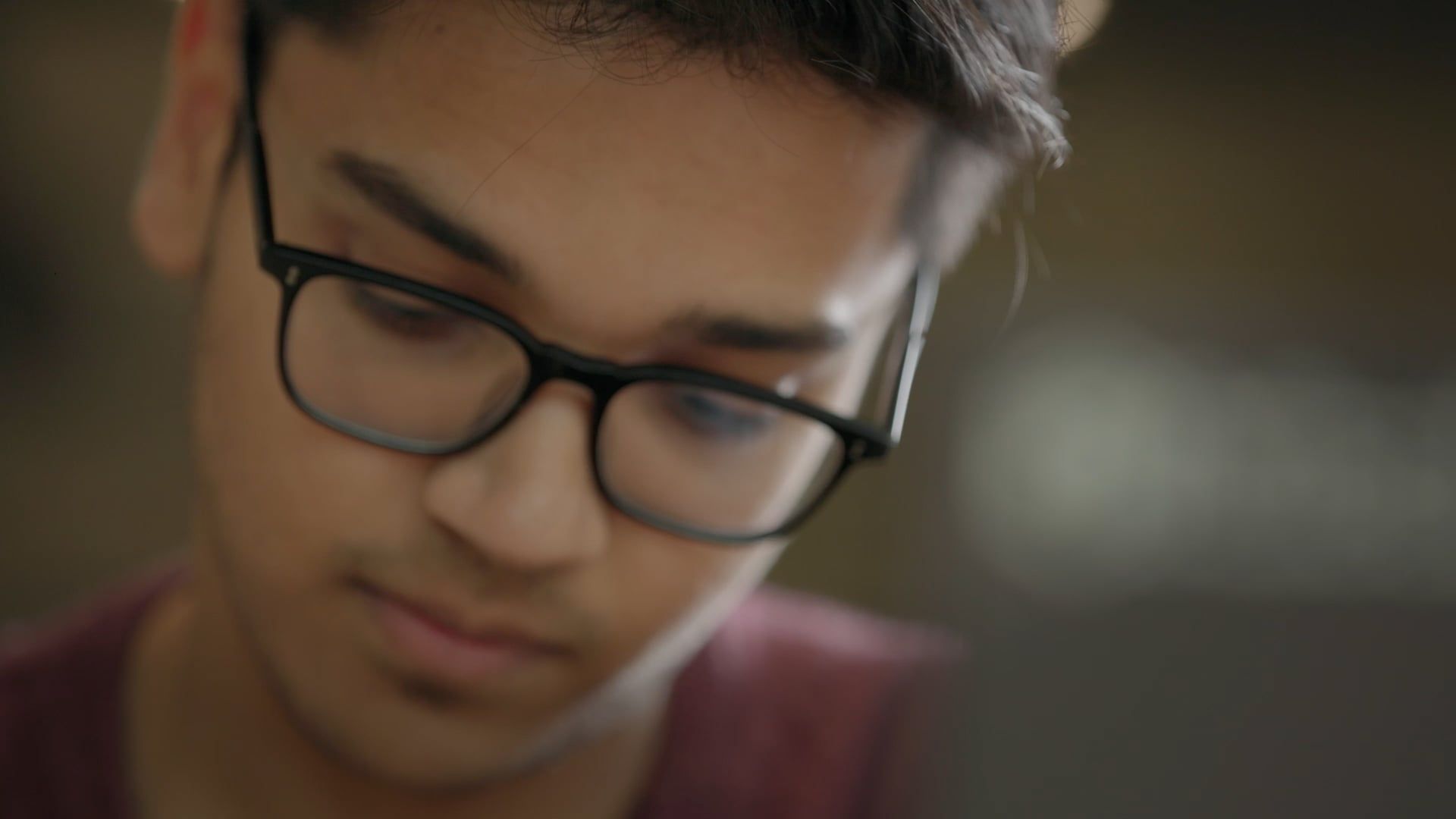 Person wearing glasses looking down