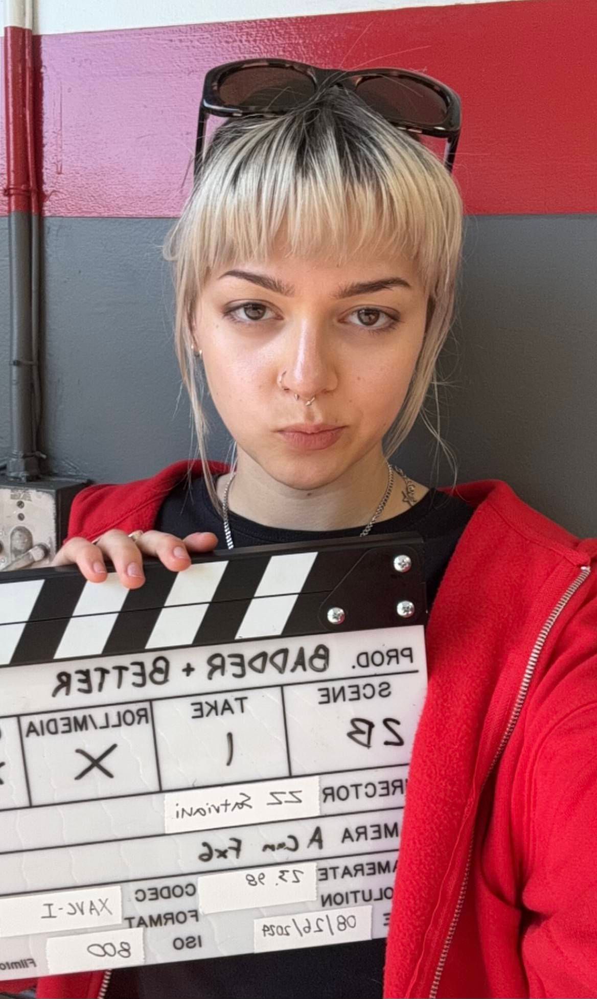 Emmy holding a slate at a production