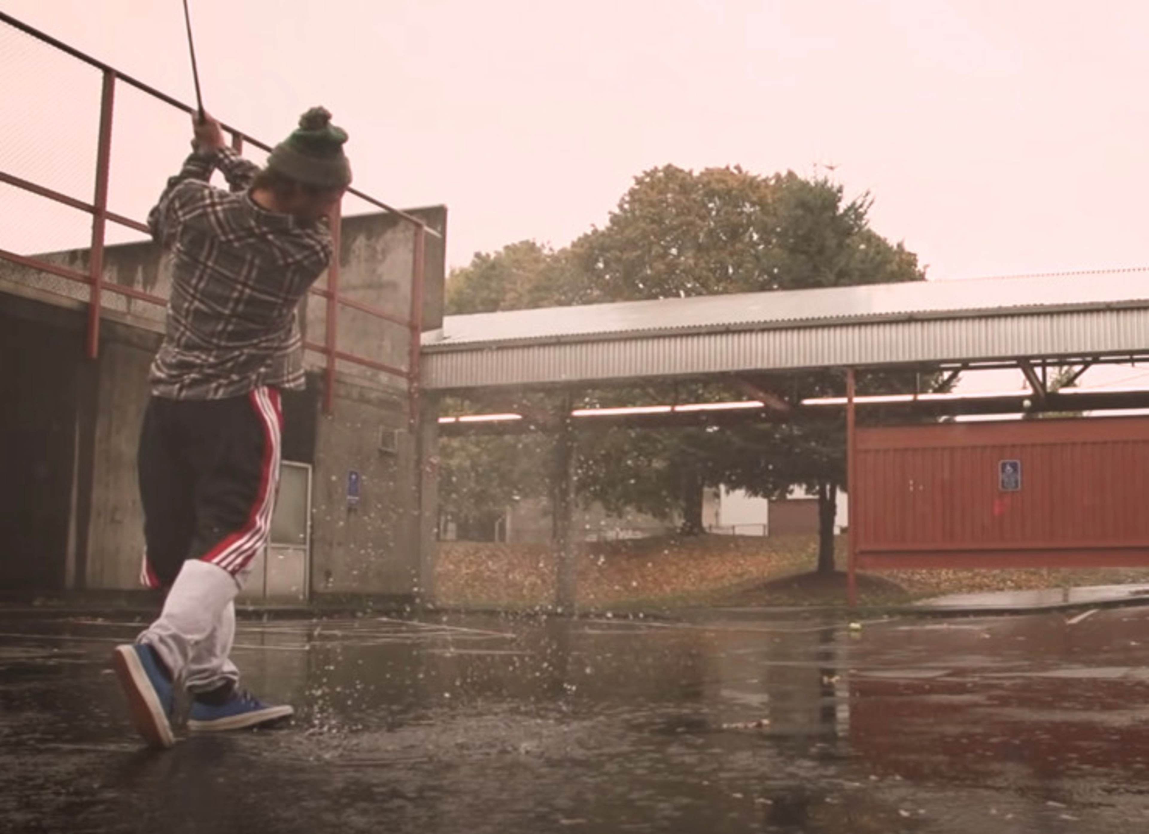 Erik Anders Lang playing street golf under the rain in Portland Oregon for a YouTube video