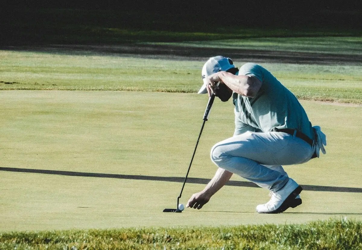 Golfer aligning his putt