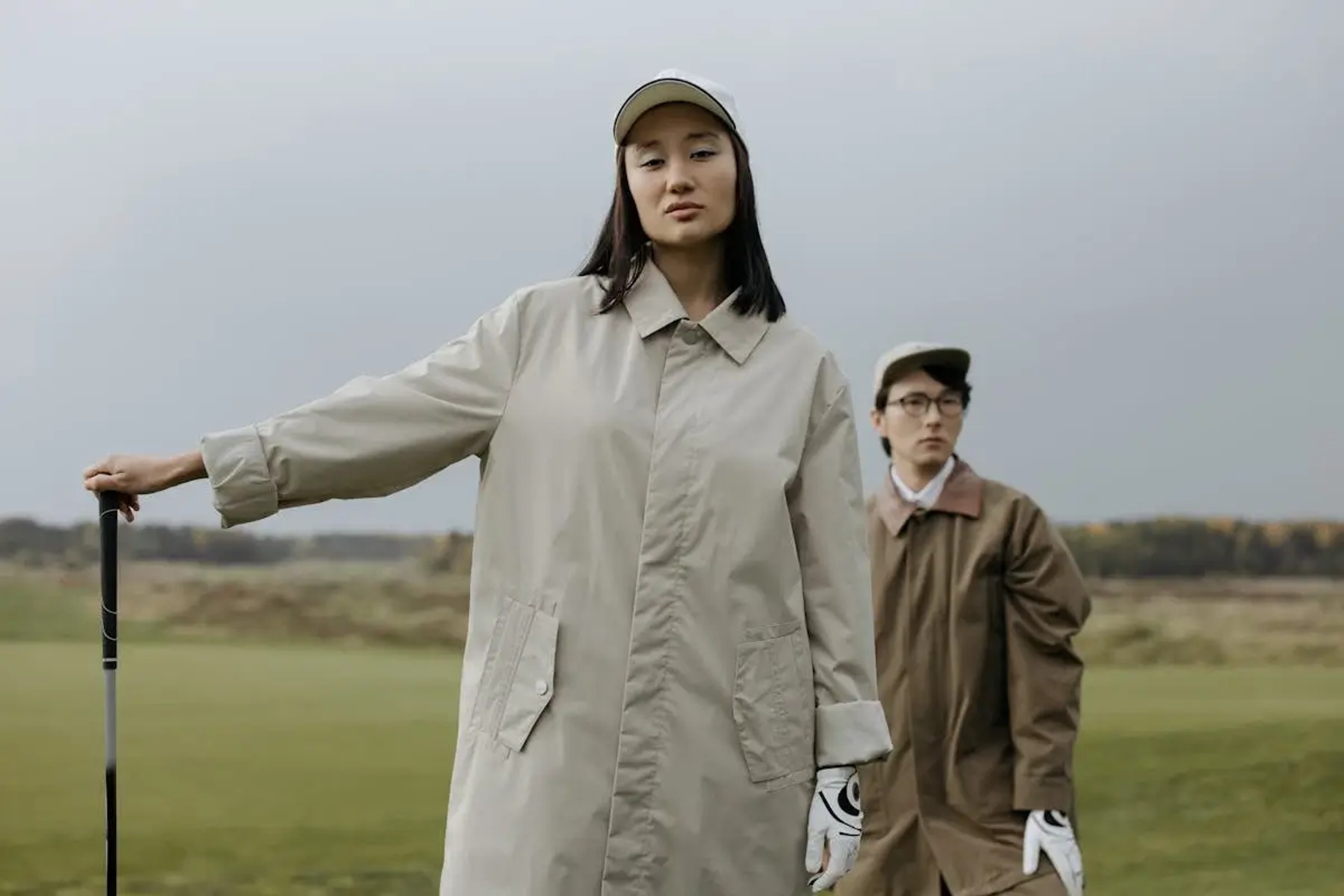 Stylish golfers wearing fashionable clothes