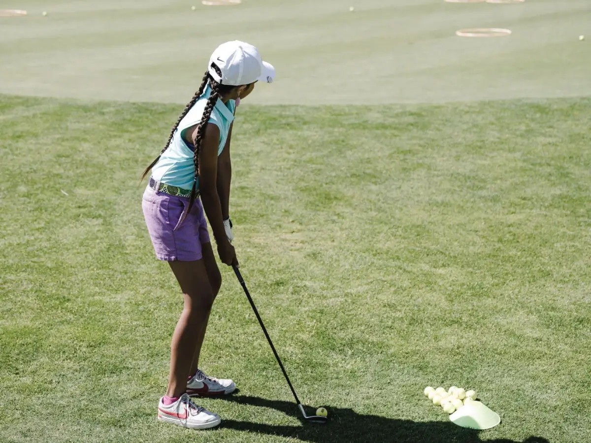 Golfer girl practicing her chipping