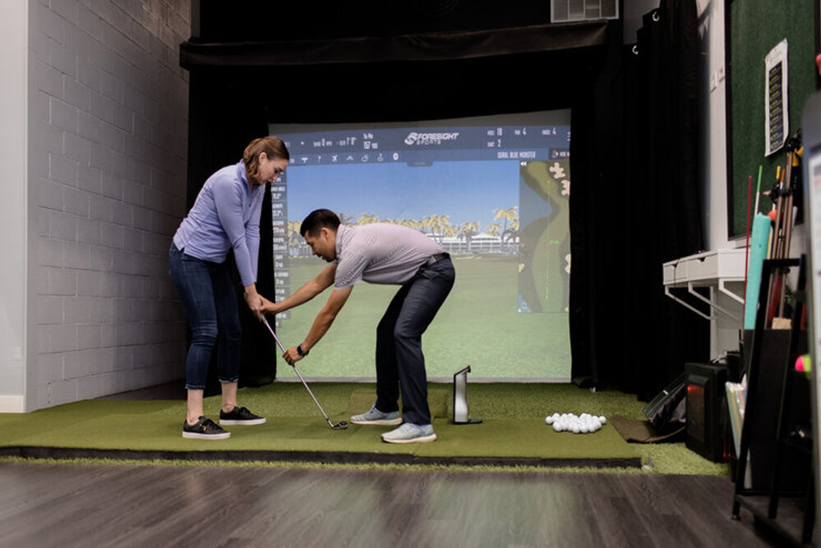 Marcus PGA professional giving a lesson on a simulator at My Golf Chicago
