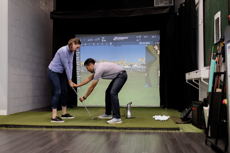 Marcus PGA professional giving a lesson on a simulator at My Golf Chicago