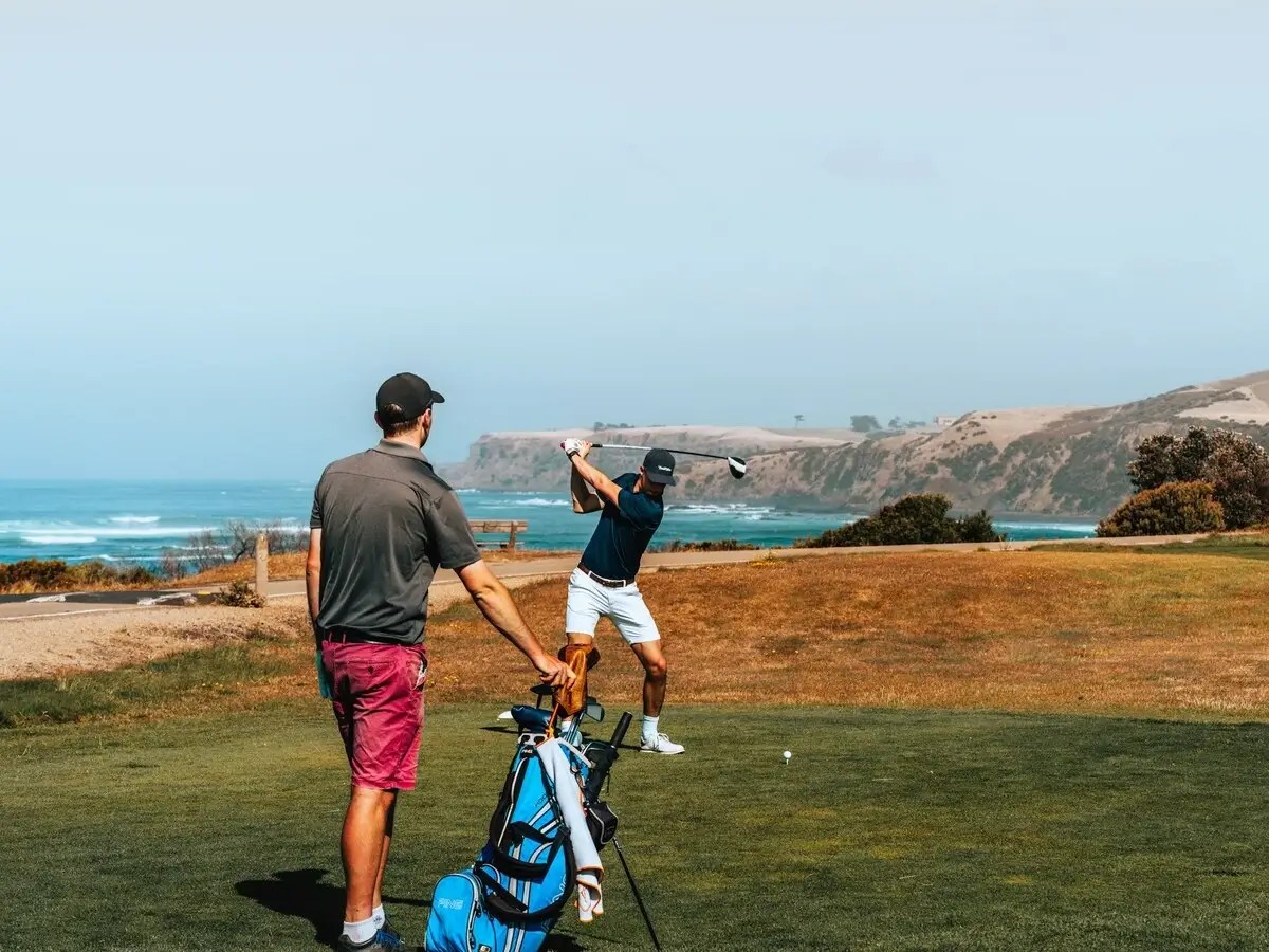 Golfers hitting their tee shot on an ocean links course
