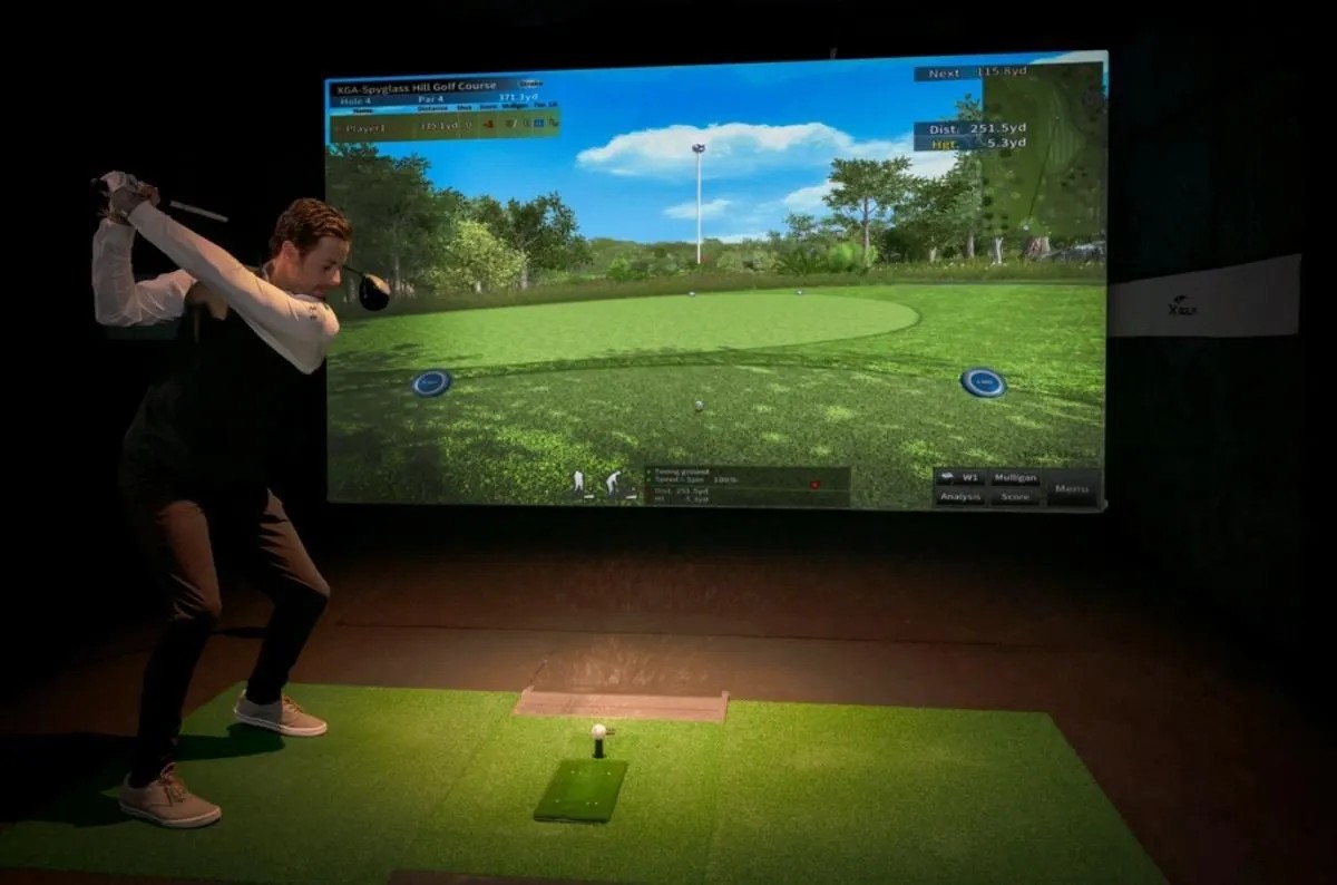 Golfer hitting a driver on a golf simulator