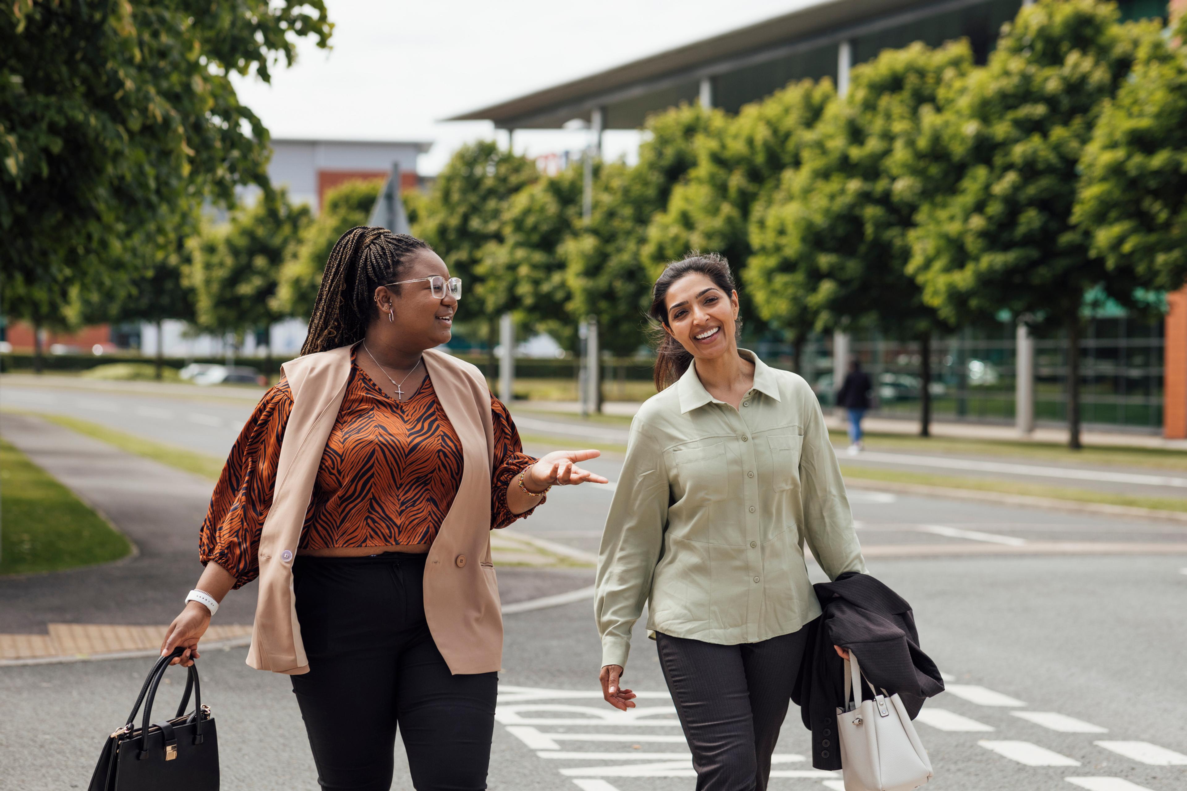 Global HR team members discussing how to hire in Sri Lanka while walking