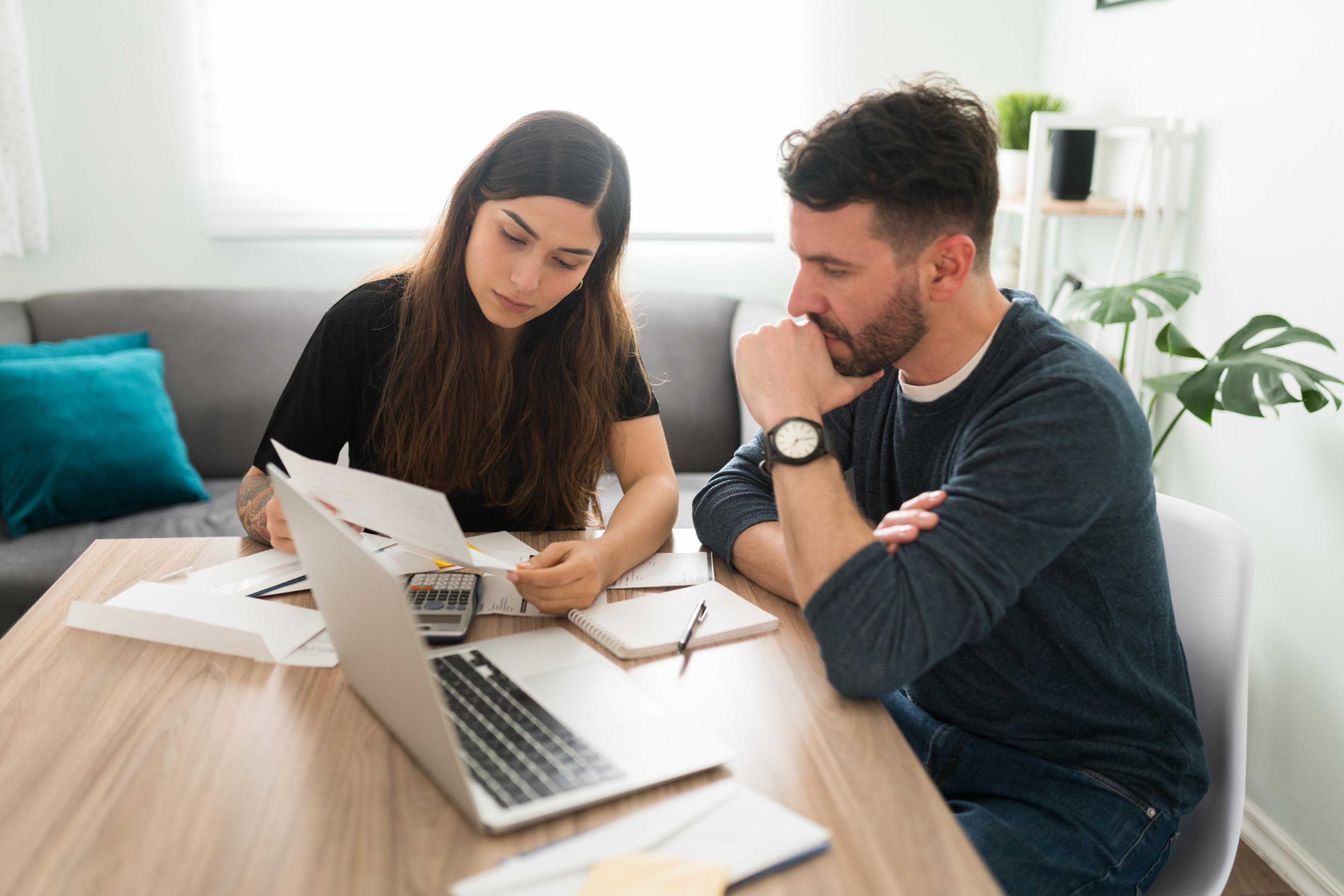 Two business owners reviewing yearly payroll taxes in Puerto Rico