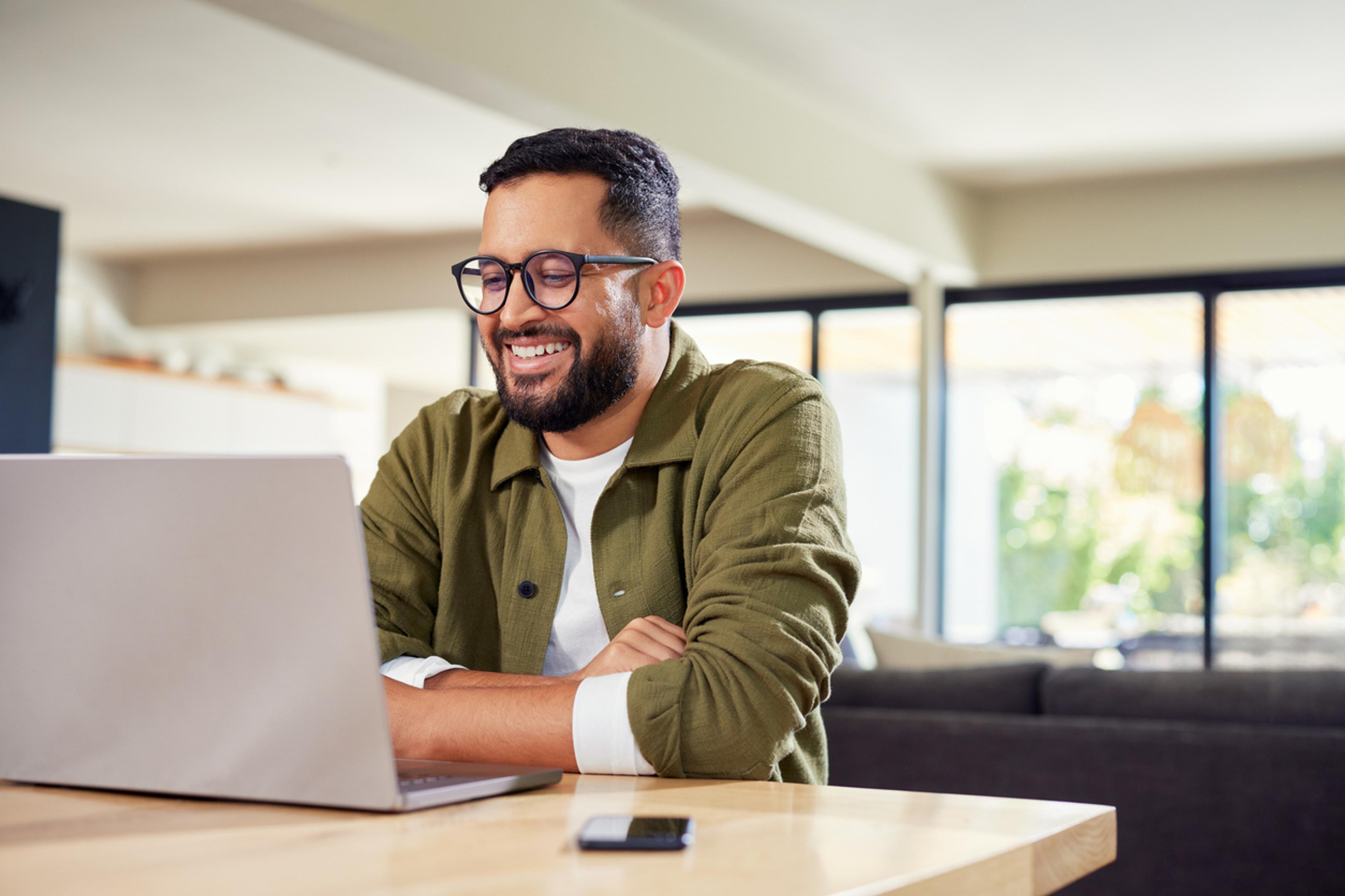 Global HR manager smiling while reading about Guinean work visas
