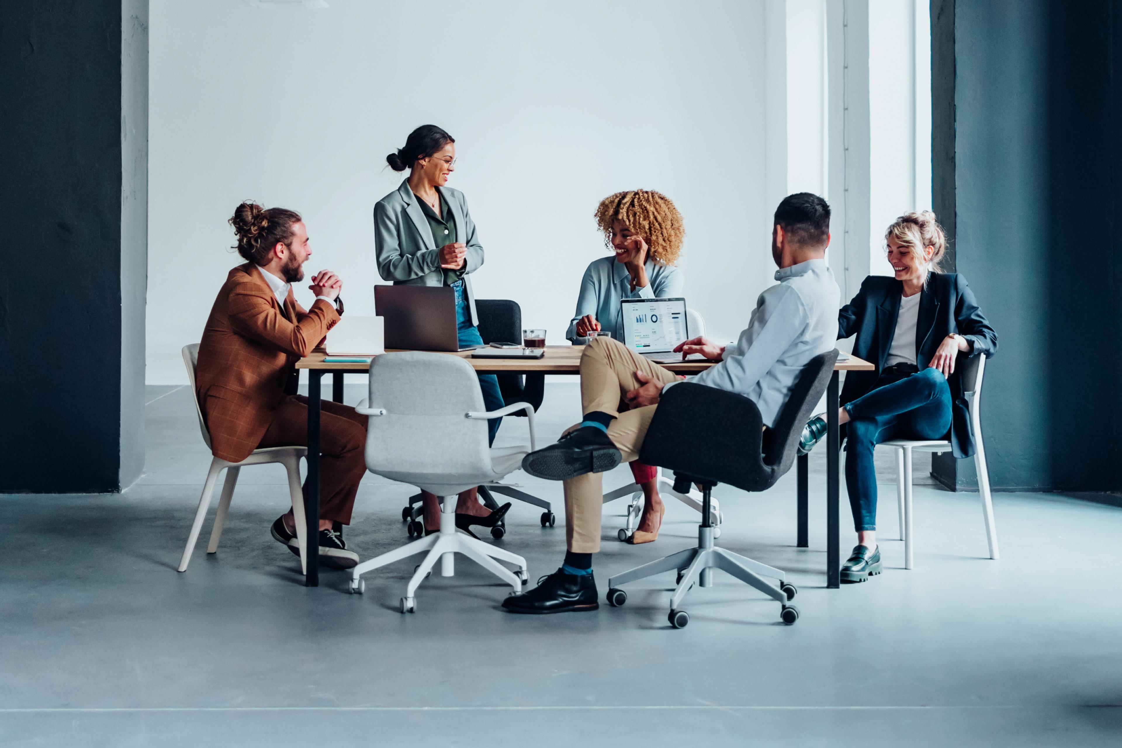 Colleagues in an office meeting discussing different types of compensation.