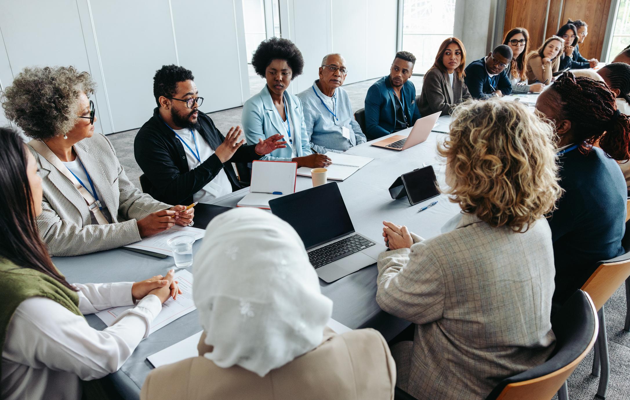 Conference room meeting discussing the impact of Trump's immigration