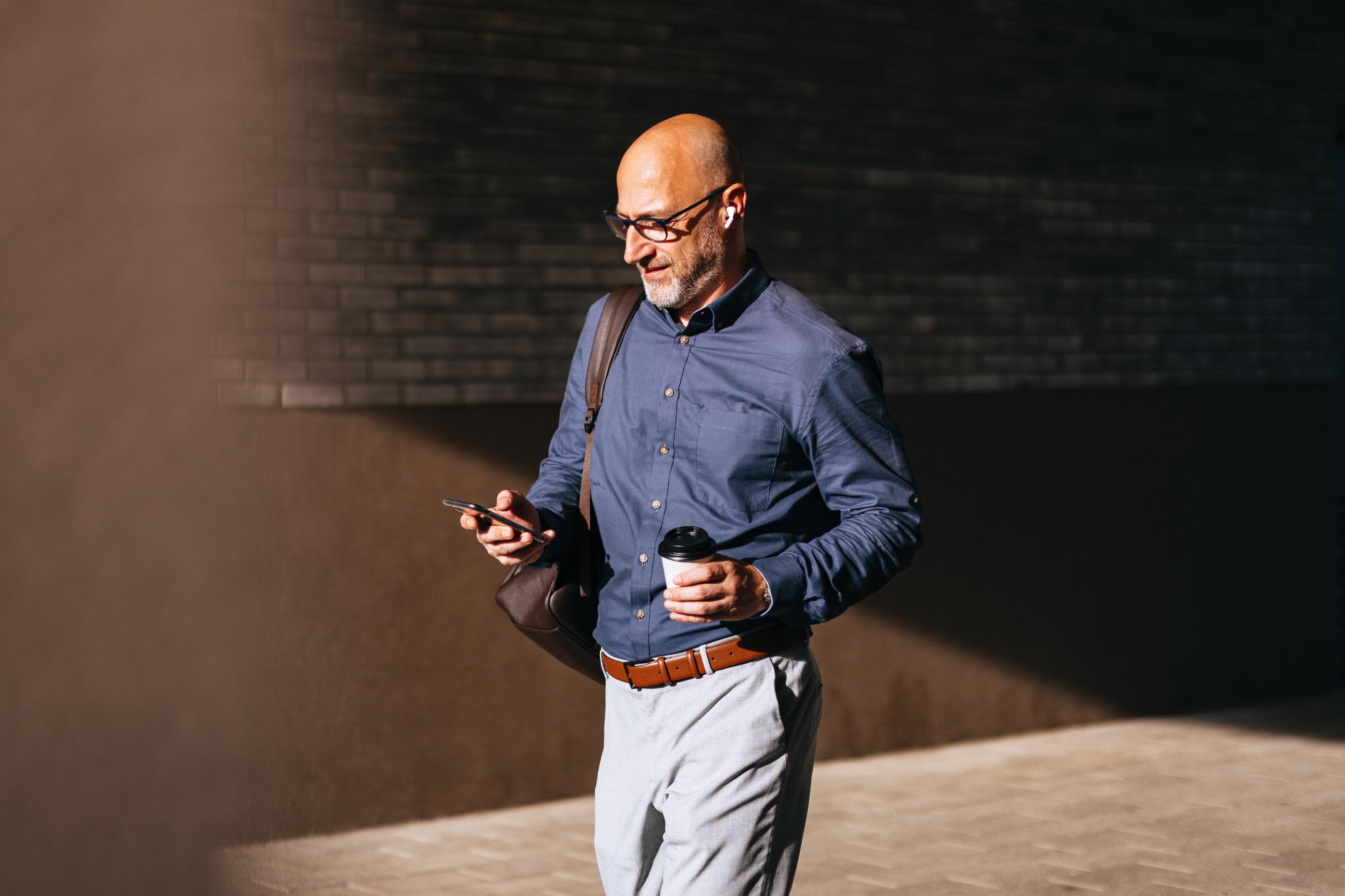 Businessman walking to the office, representing a typical earner of the average salary in Norway.