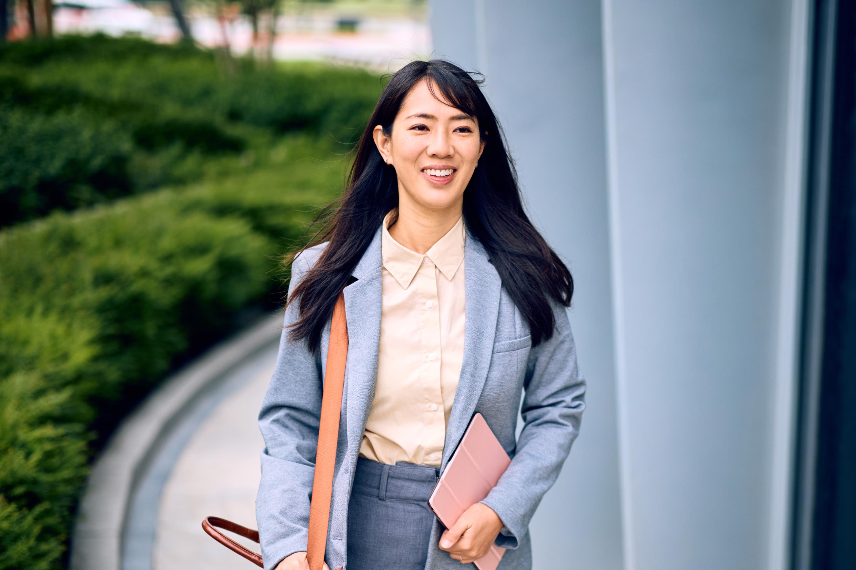 Businesswoman walking to the office, representing a typical earner of the average salary in China