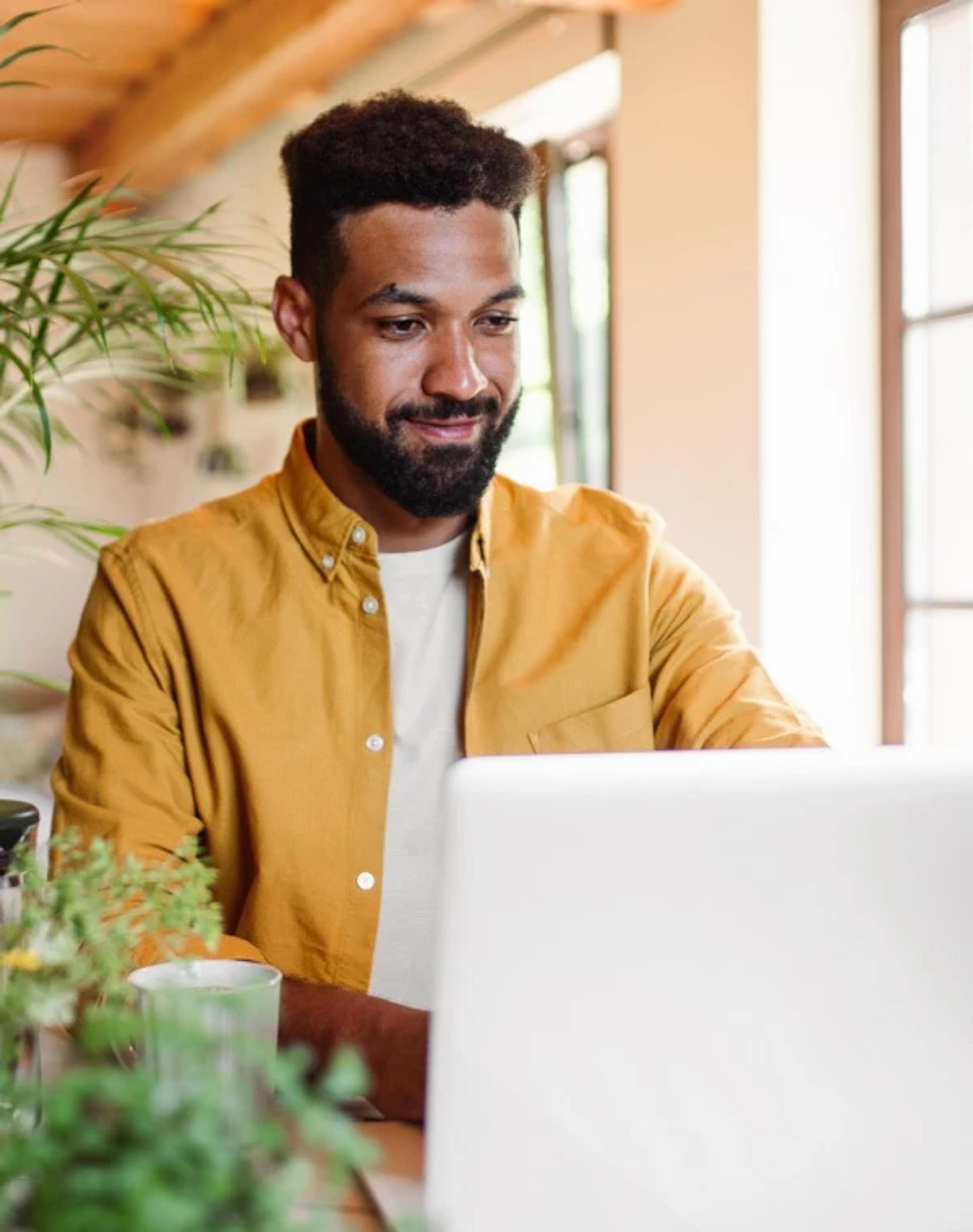 Man is working on laptop in cafe