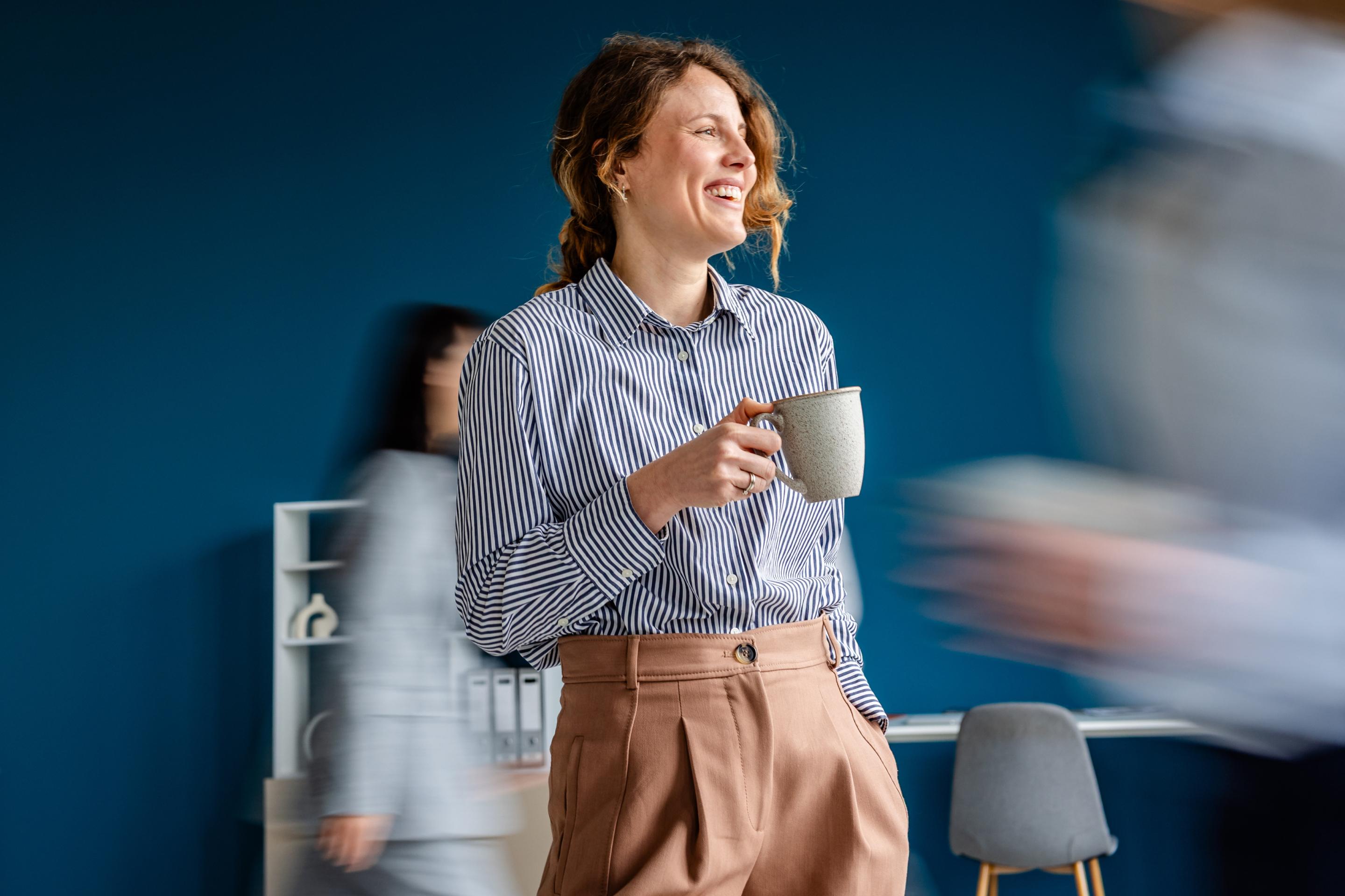 Businesswoman smiling, representing the common earner of the average salary in Finland