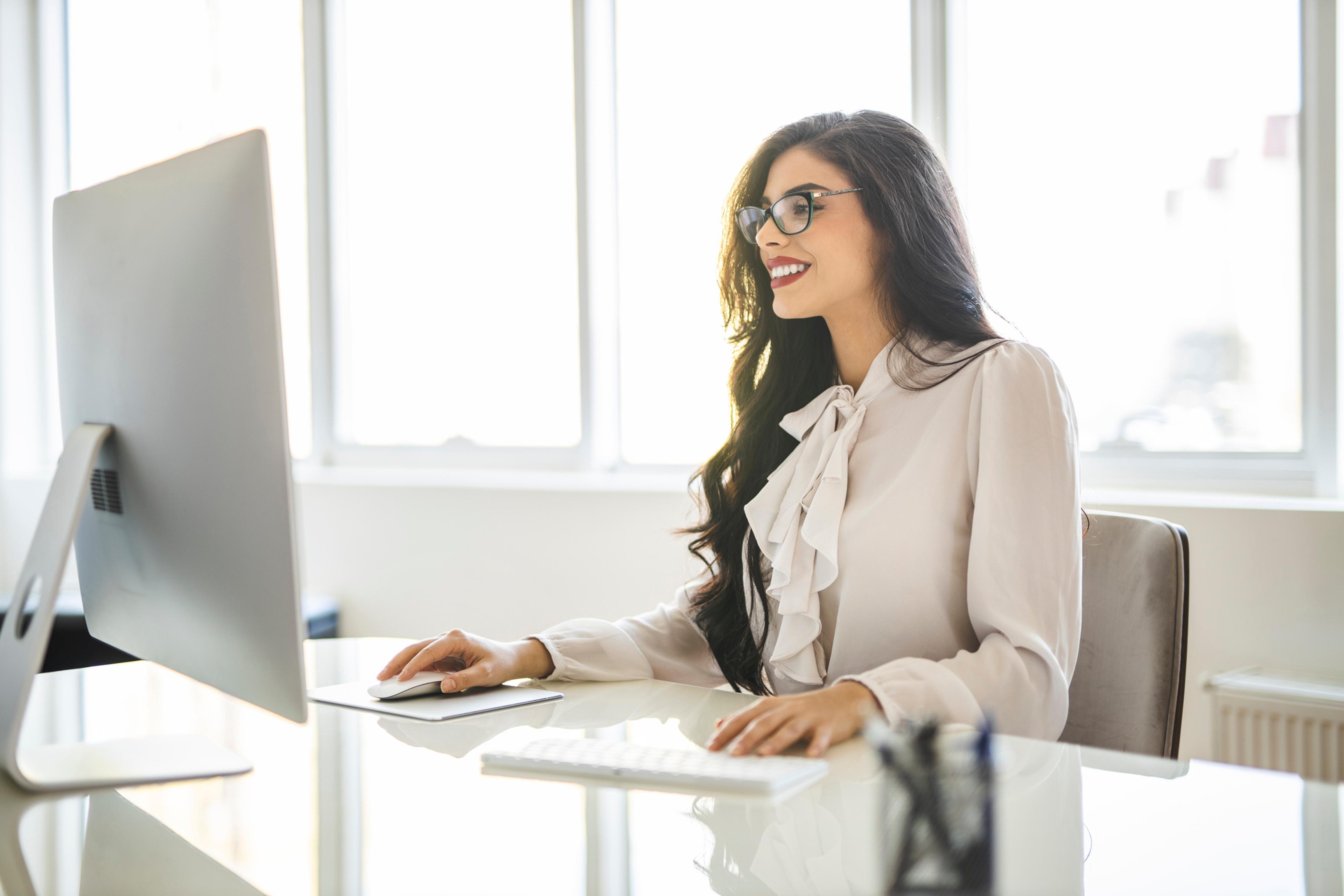 Young woman working on a computer in her office