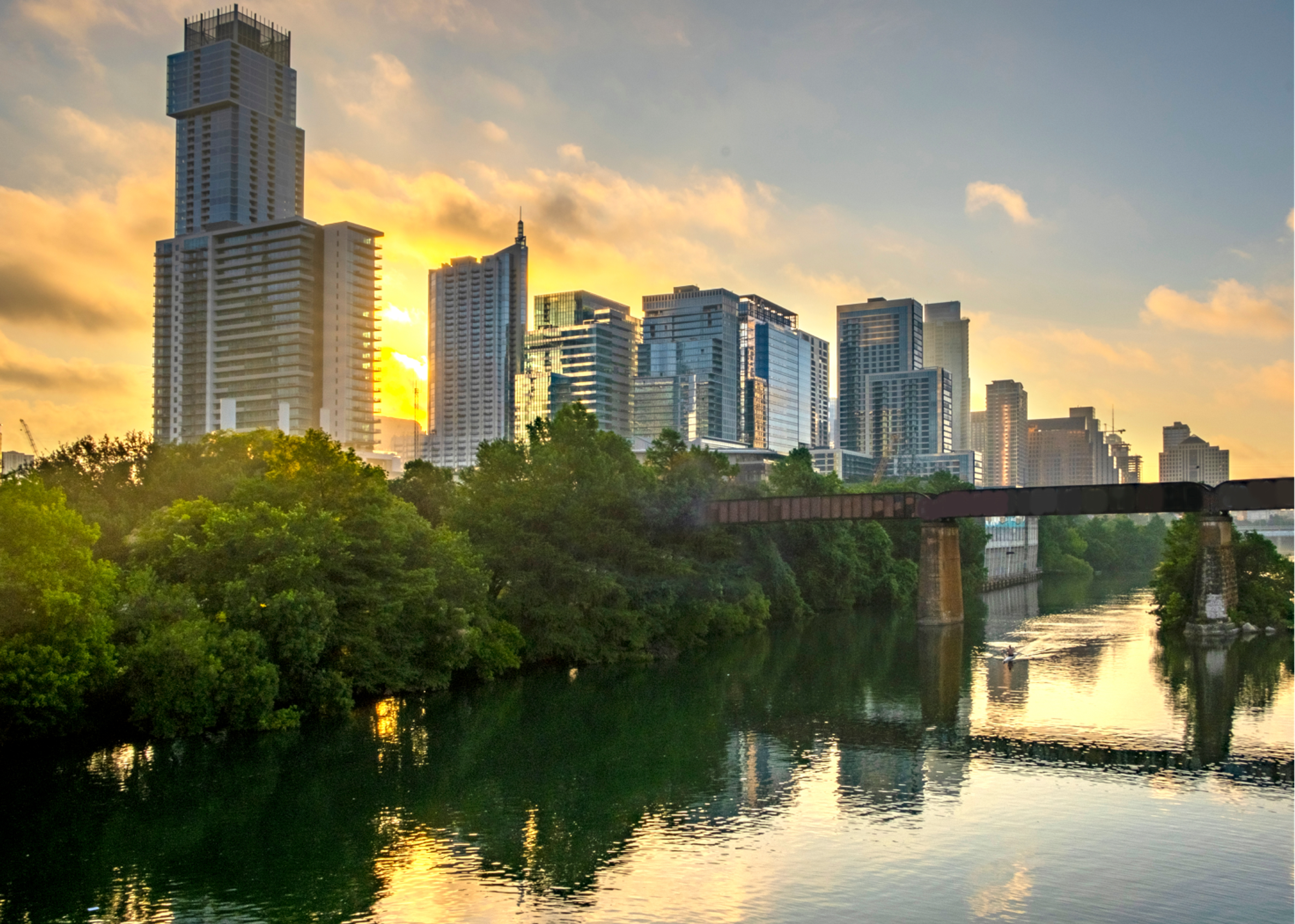 City skyline and river at sunset in the summer.