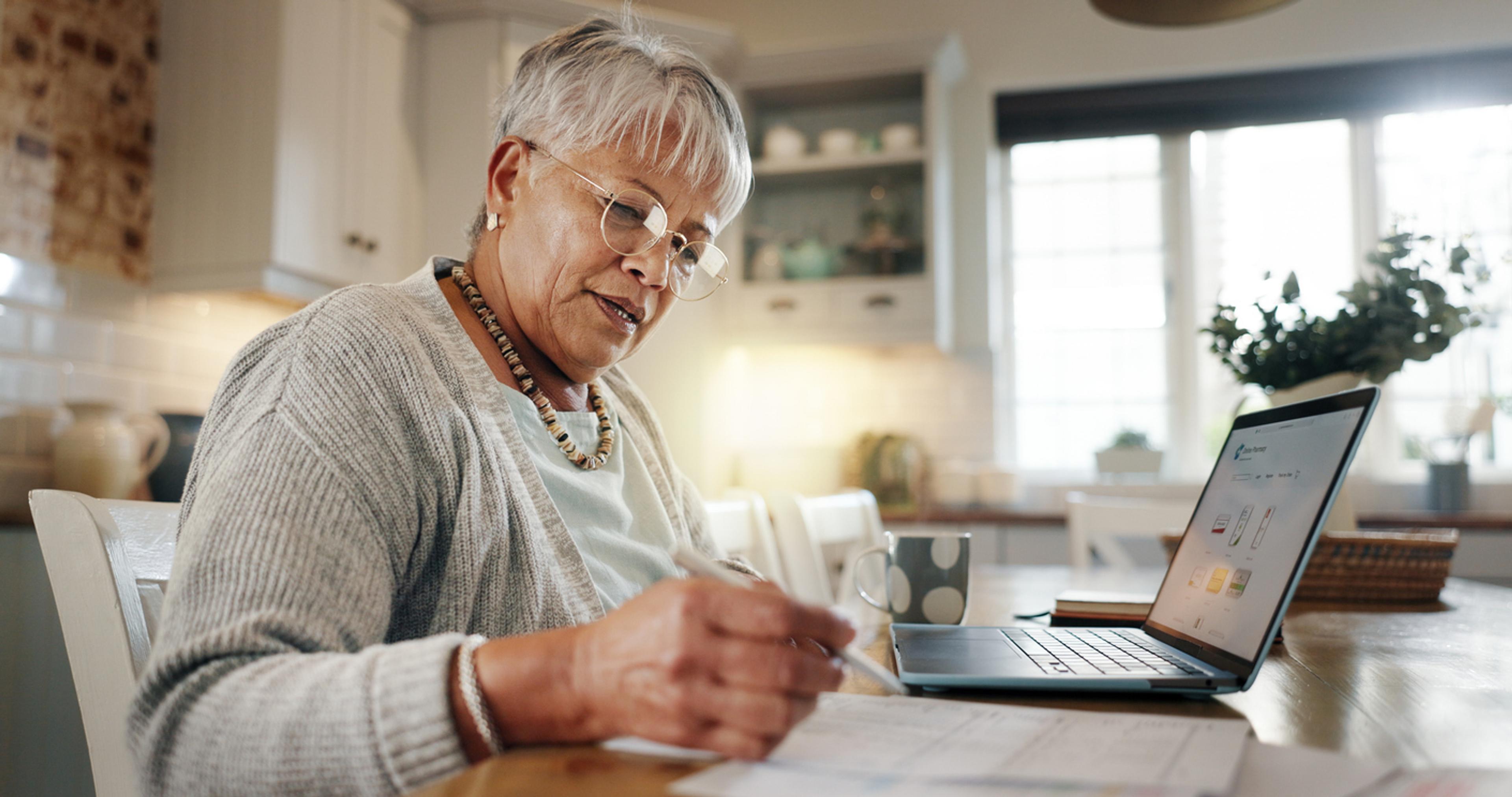 Mature woman working on payroll taxes in Tanzania