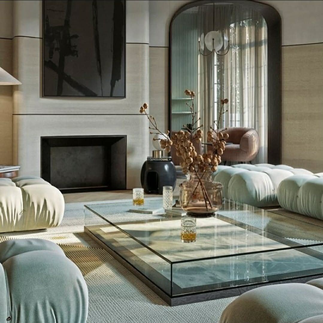 A formal living room with a stone fireplace surround and a full-height arched window