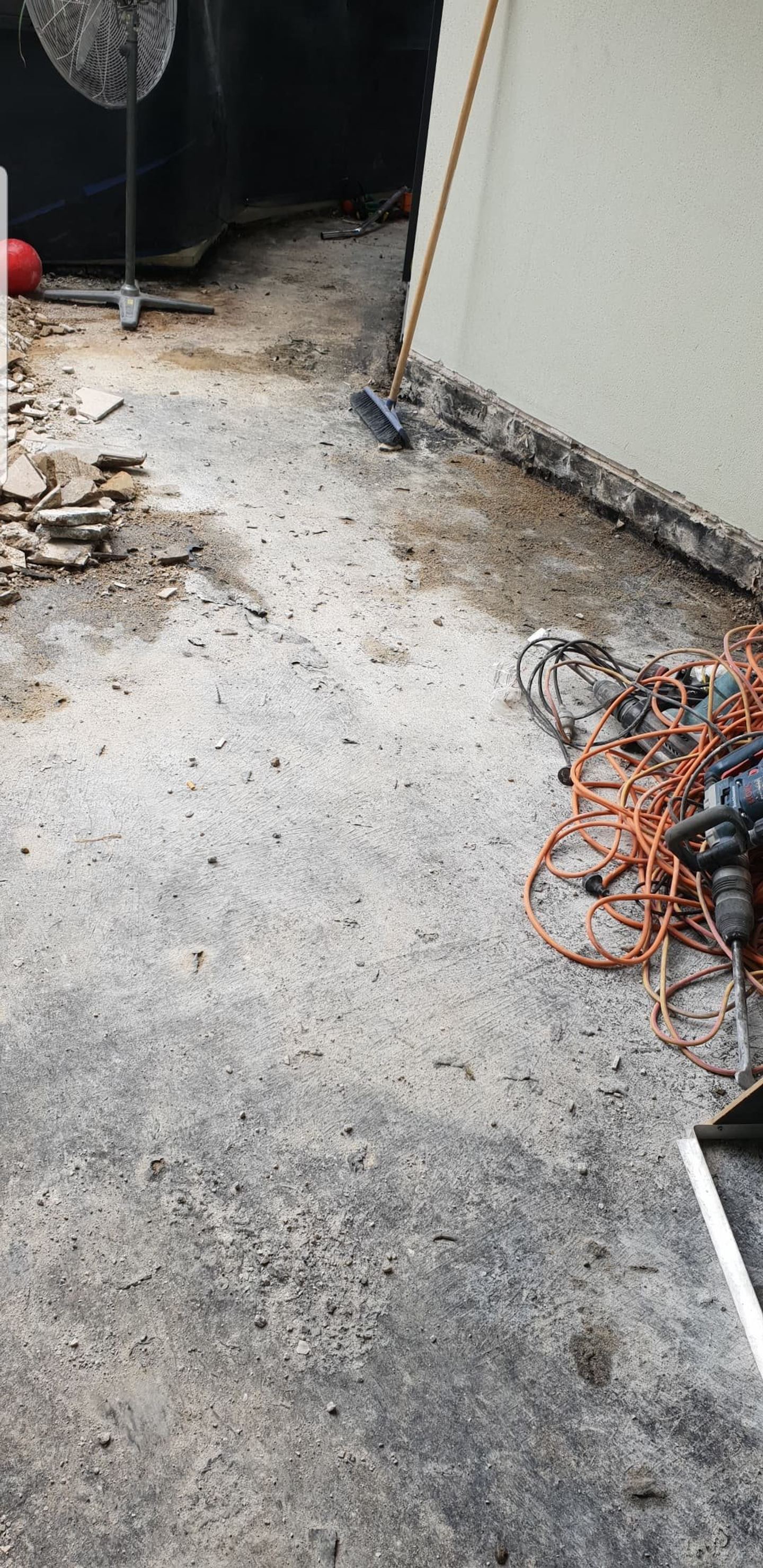 A balcony stripped back to bare concrete slab, tiles and screed removed