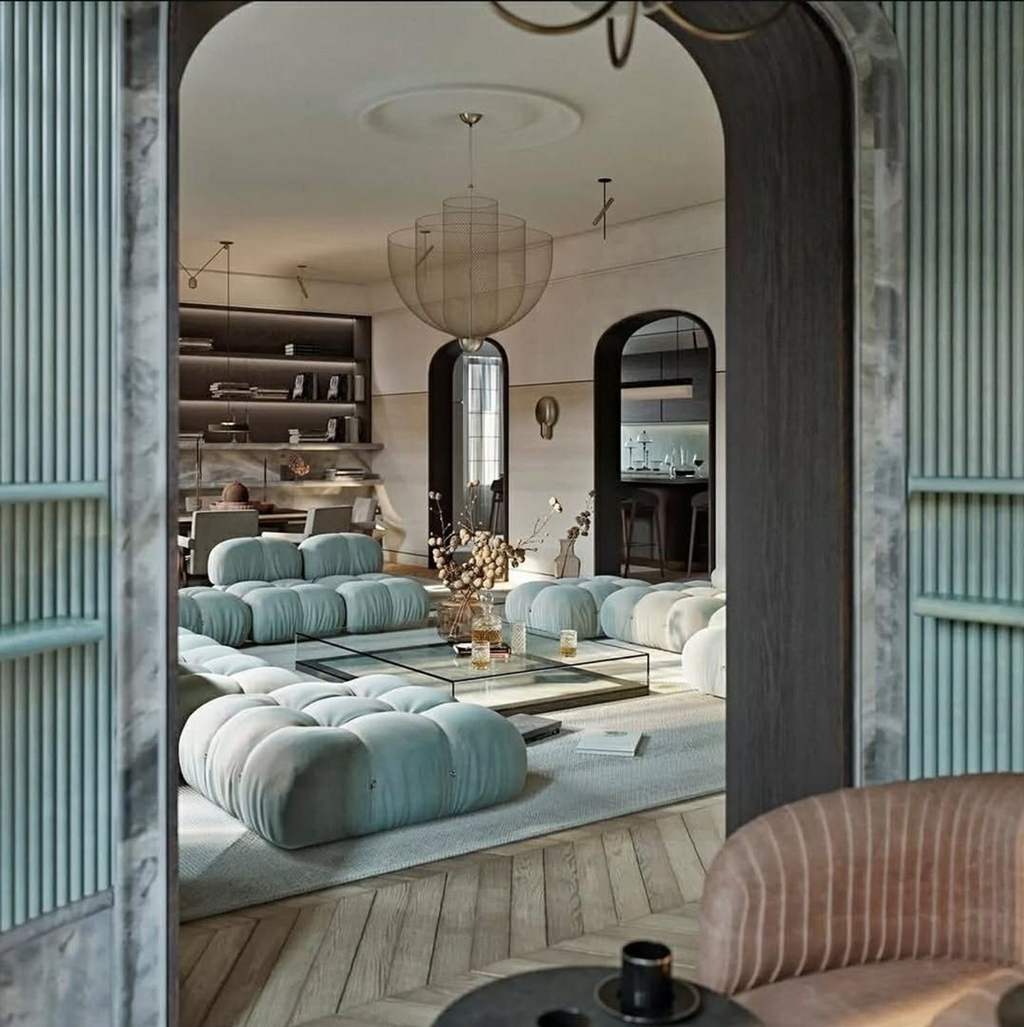 A living room seen through a wide arched opening cut between two rooms