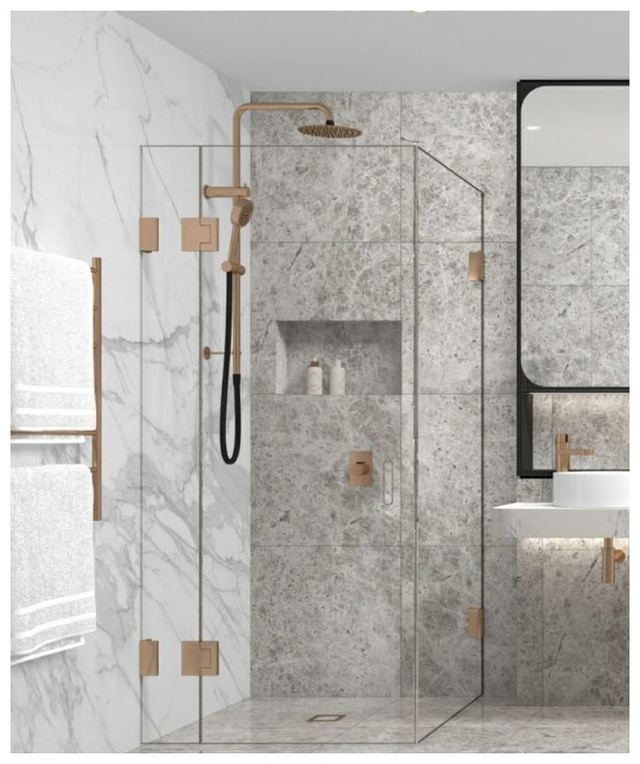 Marble-tiled bathroom with brushed copper fittings