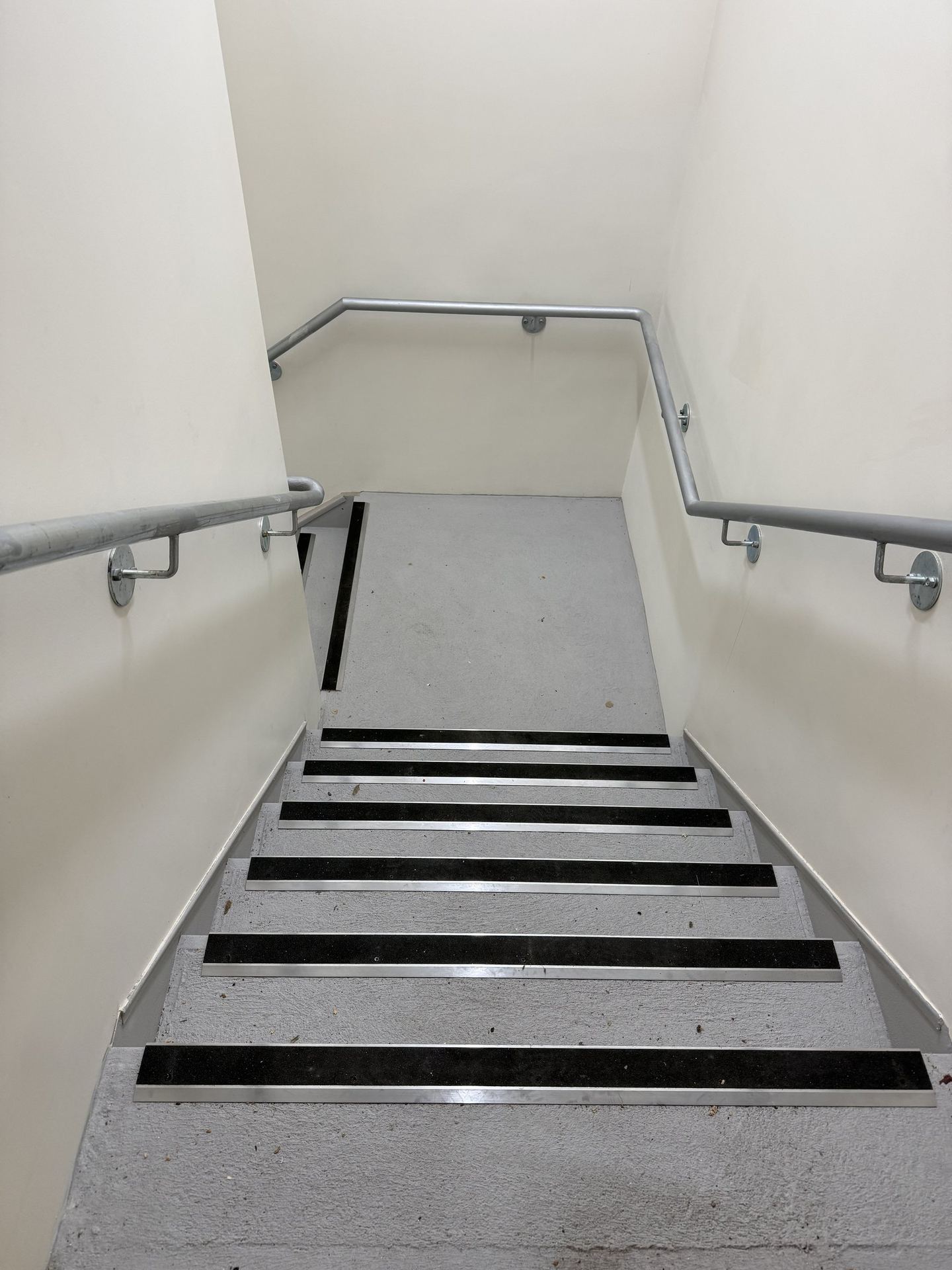 The completed fire stair with contrast nosings and a compliant handrail